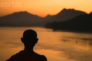 Buddhist Monk on the Mekong River at Sunset